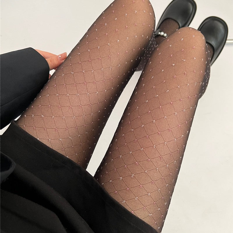 Sheer diamond-net pantyhose showing two legs, pink mesh with black contrast