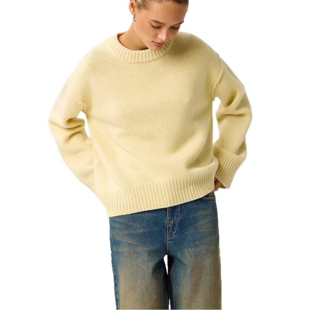Women's light yellow round-neck knit pullover sweater with ribbed cuffs and hem