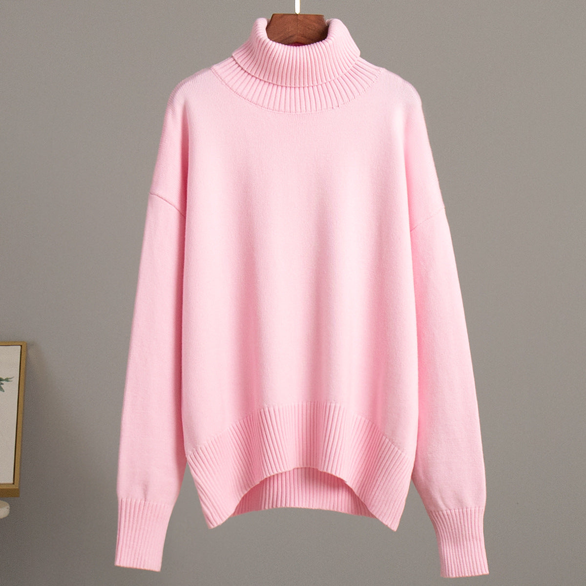 Light pink knit turtleneck pullover sweater with loose fit and ribbed cuffs