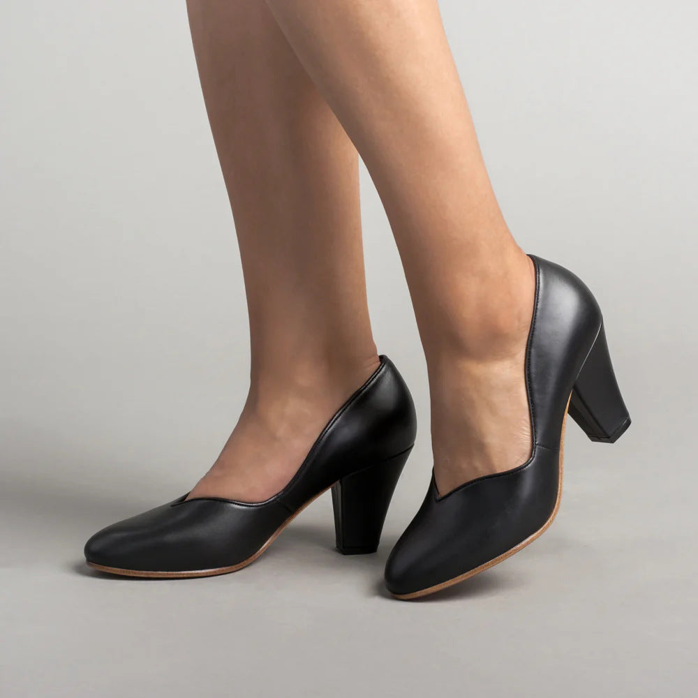 Black pumps with a V-cut topline and thick block heels, shown from the side