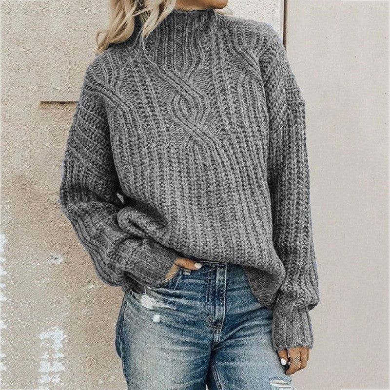 Women's grey cable knit turtleneck sweater with long sleeves and ribbed cuffs