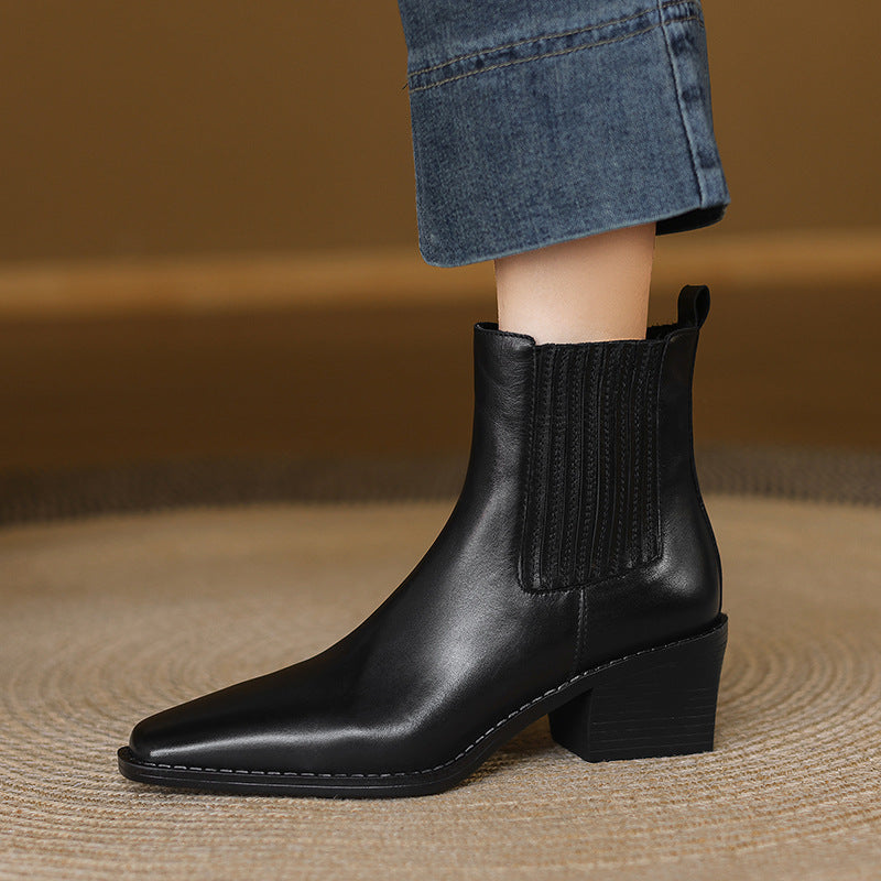 Black leather Chelsea boots with square toe and thick block heel, side elastic gore view