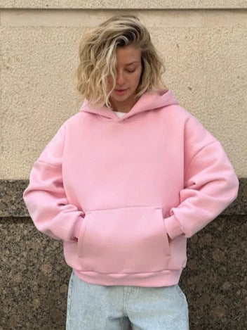 Pink women’s hooded sweatshirt with front kangaroo pocket and relaxed long sleeves