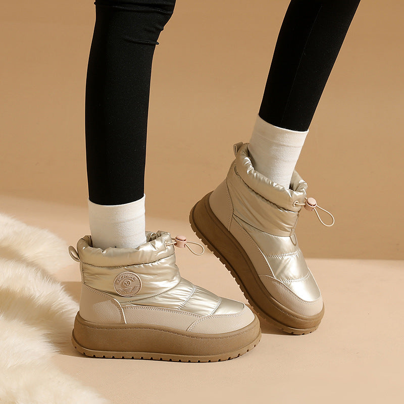 Pair of women's khaki snow boots with lace-up front and padded ankle collar
