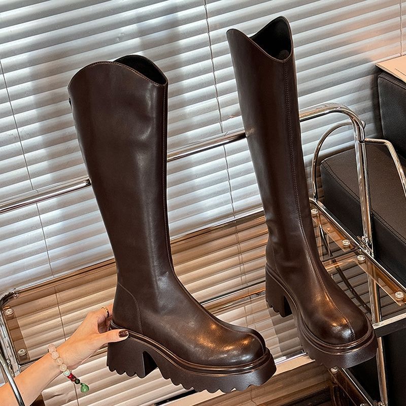Brown knee-high platform lug boots with scalloped cuff and chunky block heel