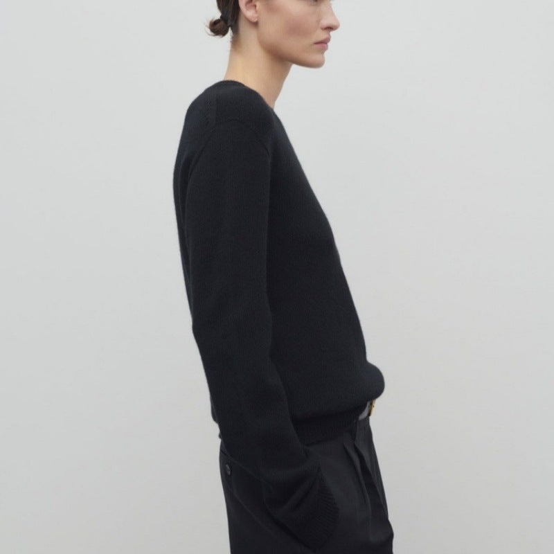Women's black knit pullover with long sleeves and crew neck, side view