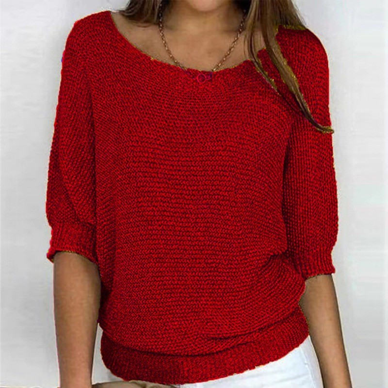 Red knit top with round neck and three-quarter sleeves, ribbed hem and cuffs