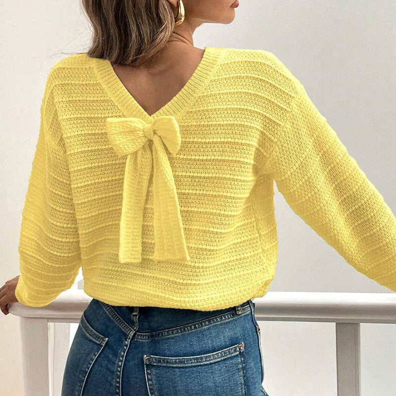 Yellow knit sweater with back bow detail and V-back neckline