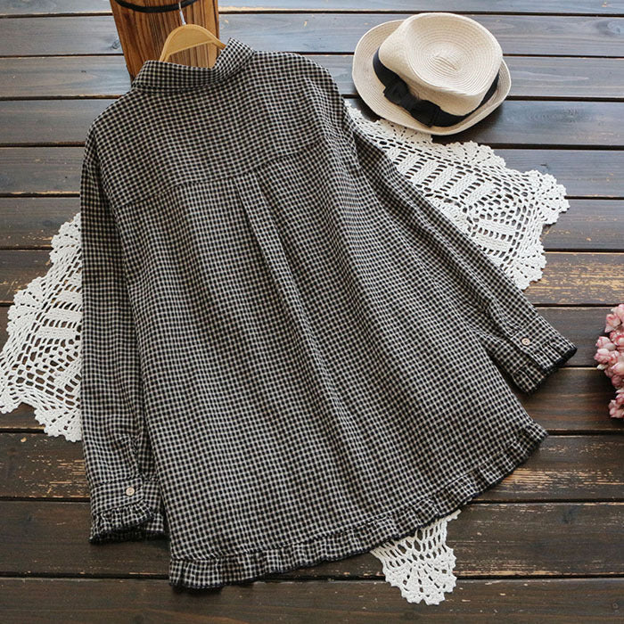 Plaid swing top viewed from back, with long sleeves and tiered high-low hem