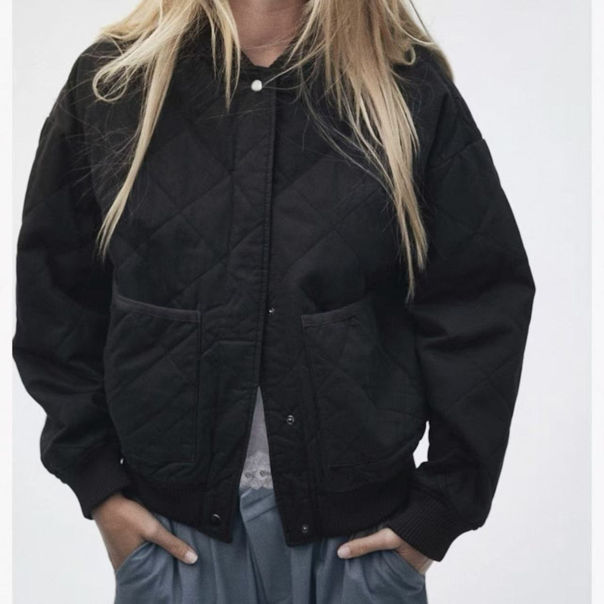 Black quilted cotton bomber jacket with stand collar and snap-front pockets