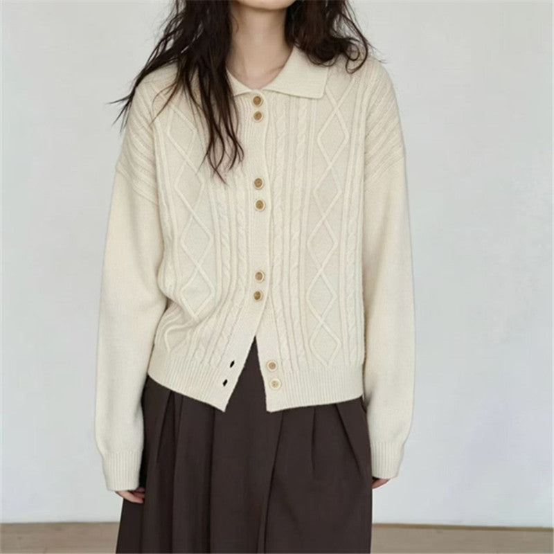Off-white cardigan with cable-knit panels, pointed collar and button front