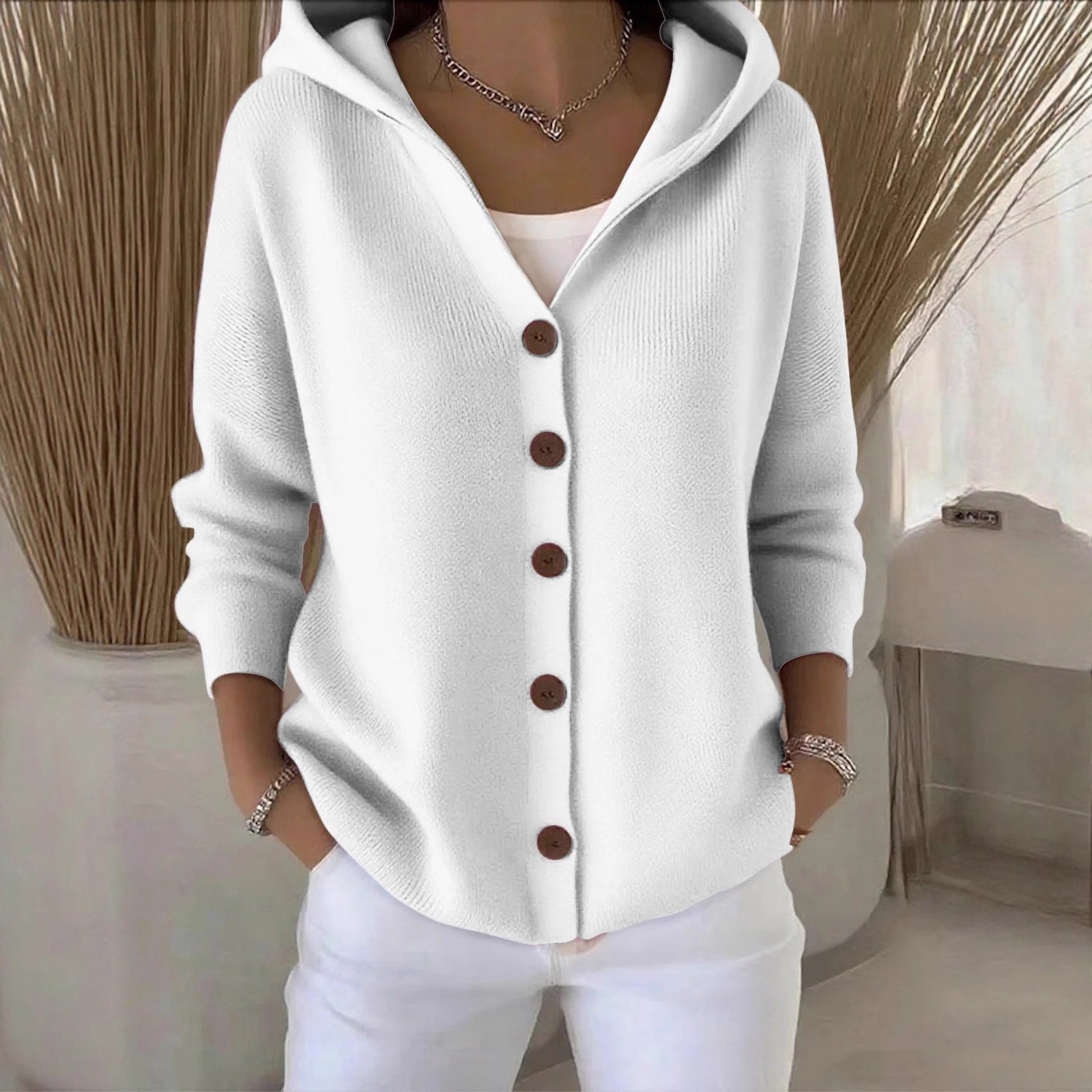 White hooded knit cardigan with button-front placket and long sleeves