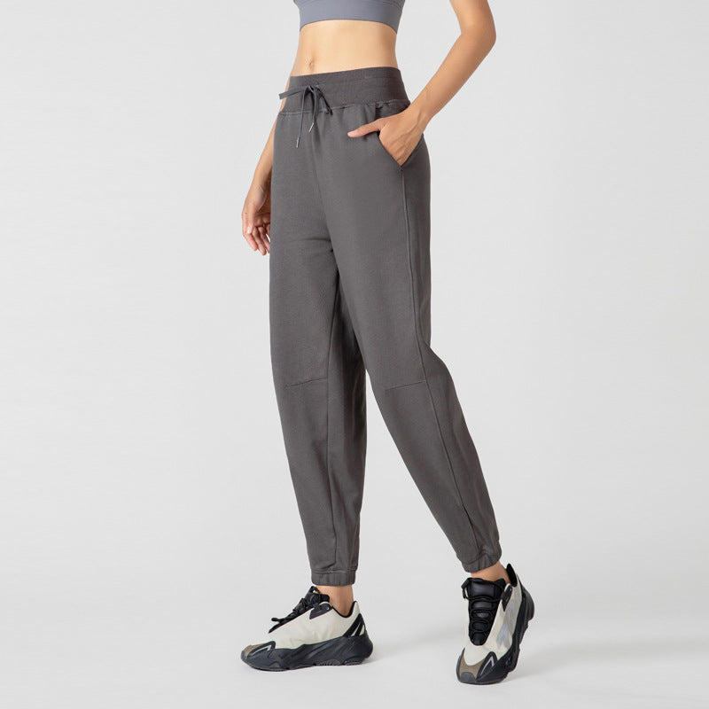 High-waisted charcoal jogger pants with drawstring, side pockets, and elastic cuffs