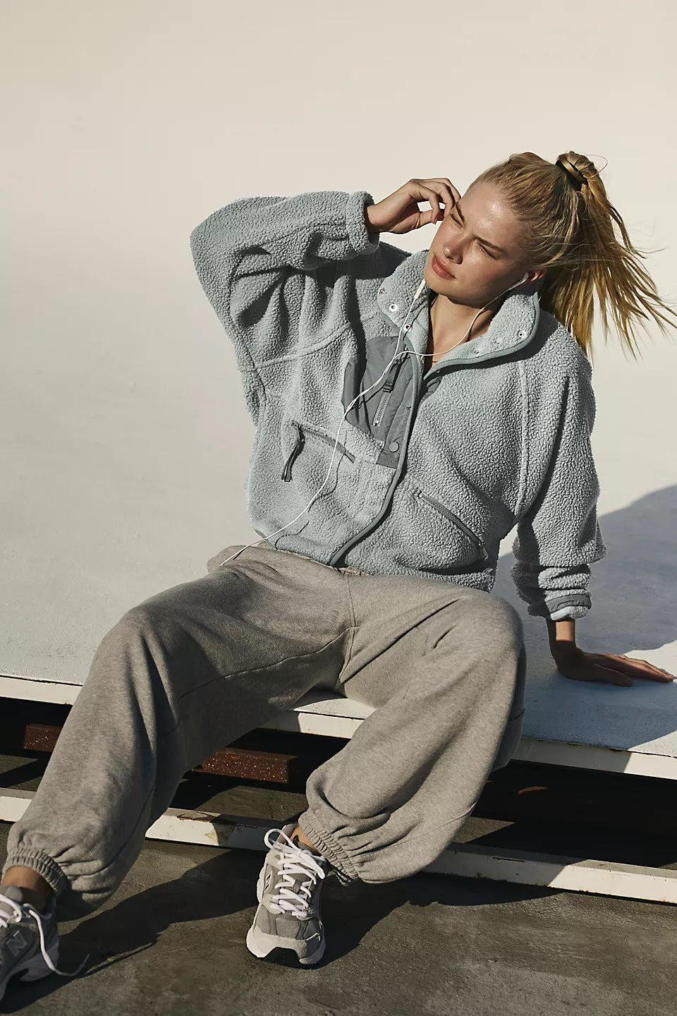 Women’s light gray plush zip-up jacket with vertical collar and drawstring detail