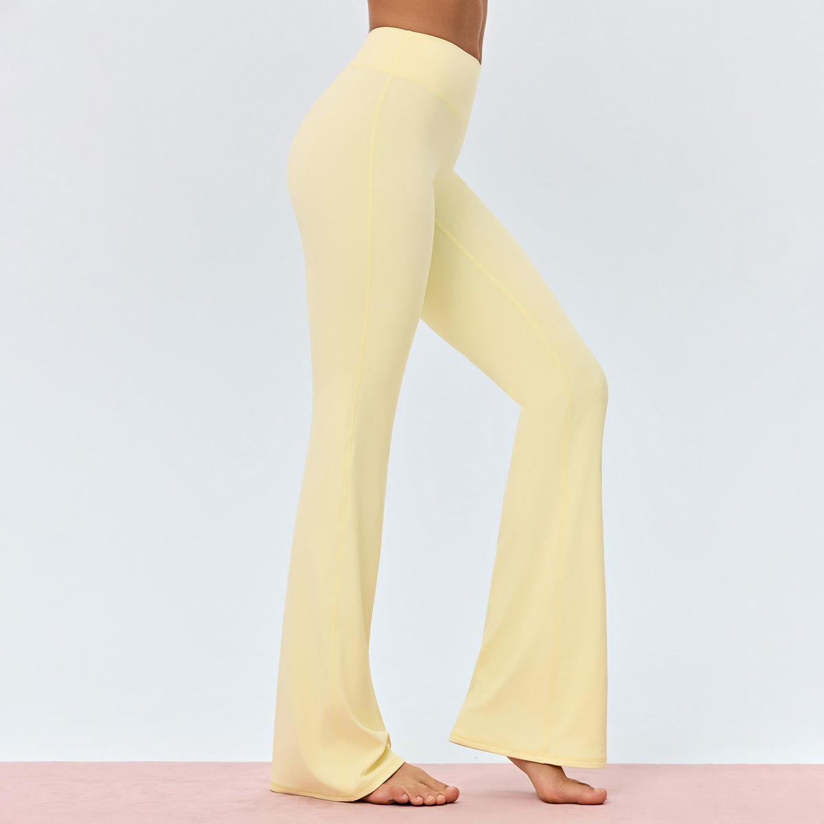 Women’s high-waisted yoga flared pants in light yellow, side view wide leg