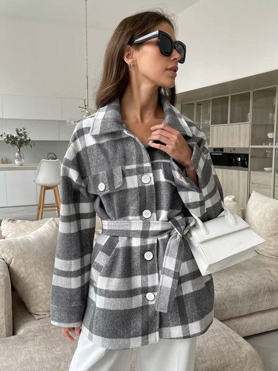 Gray and white plaid coat with button front, chest pockets, and tied waist belt