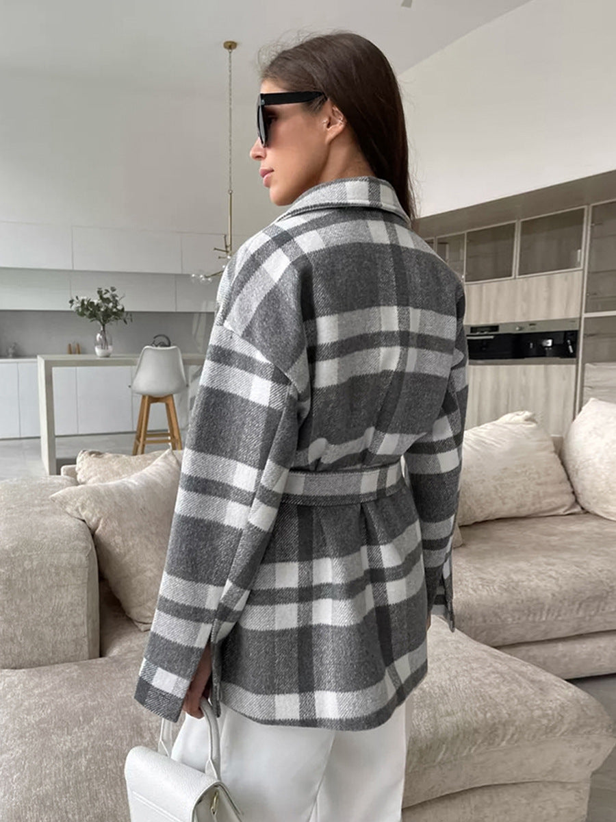 Back view of gray and white plaid coat with a belt tied at the waist