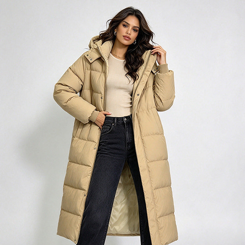 Women’s long beige hooded puffer coat with front buttons and wide quilted shoulders.