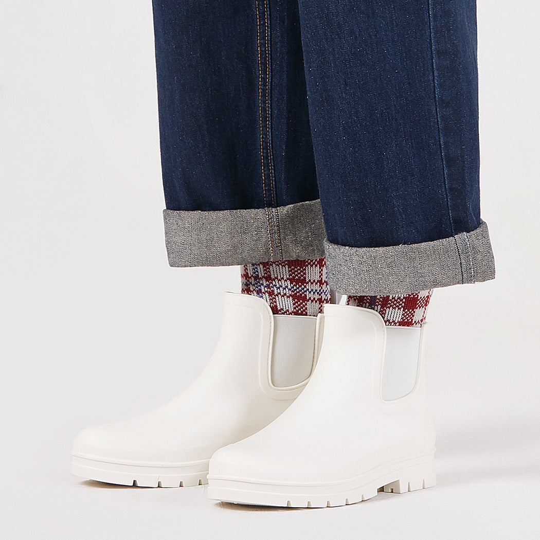 Milky white short rain boots with pull-on side panels and grippy tread sole