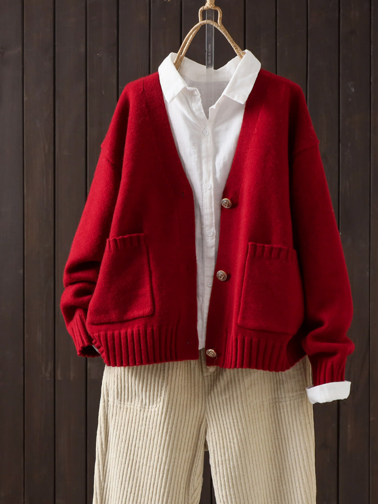Red wool cardigan on hanger with V-neck button front and patch pockets