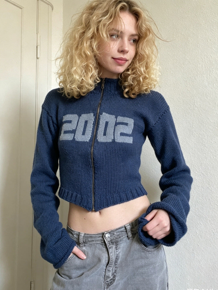 Blue cropped knit sweater with half-high collar, front zipper, long bell sleeves, 2002 print