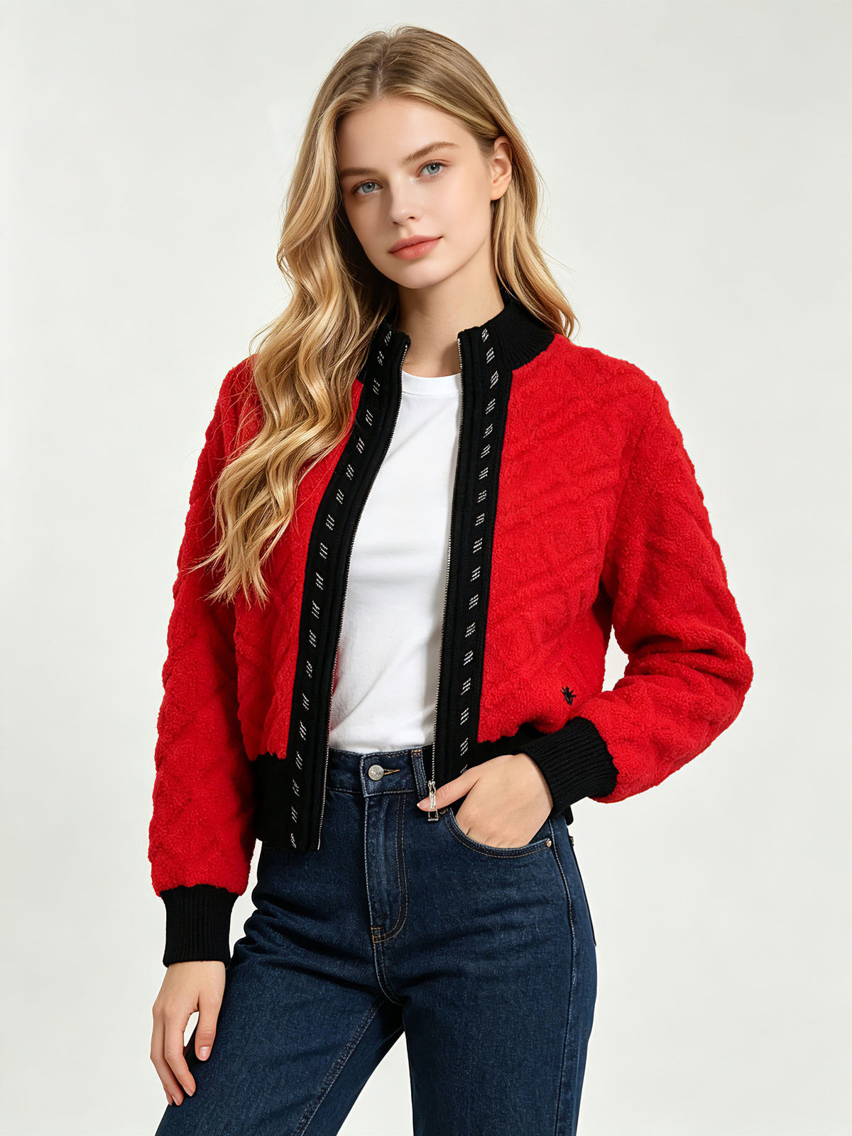 Red cable-knit cardigan with black contrast zip placket and stand collar.