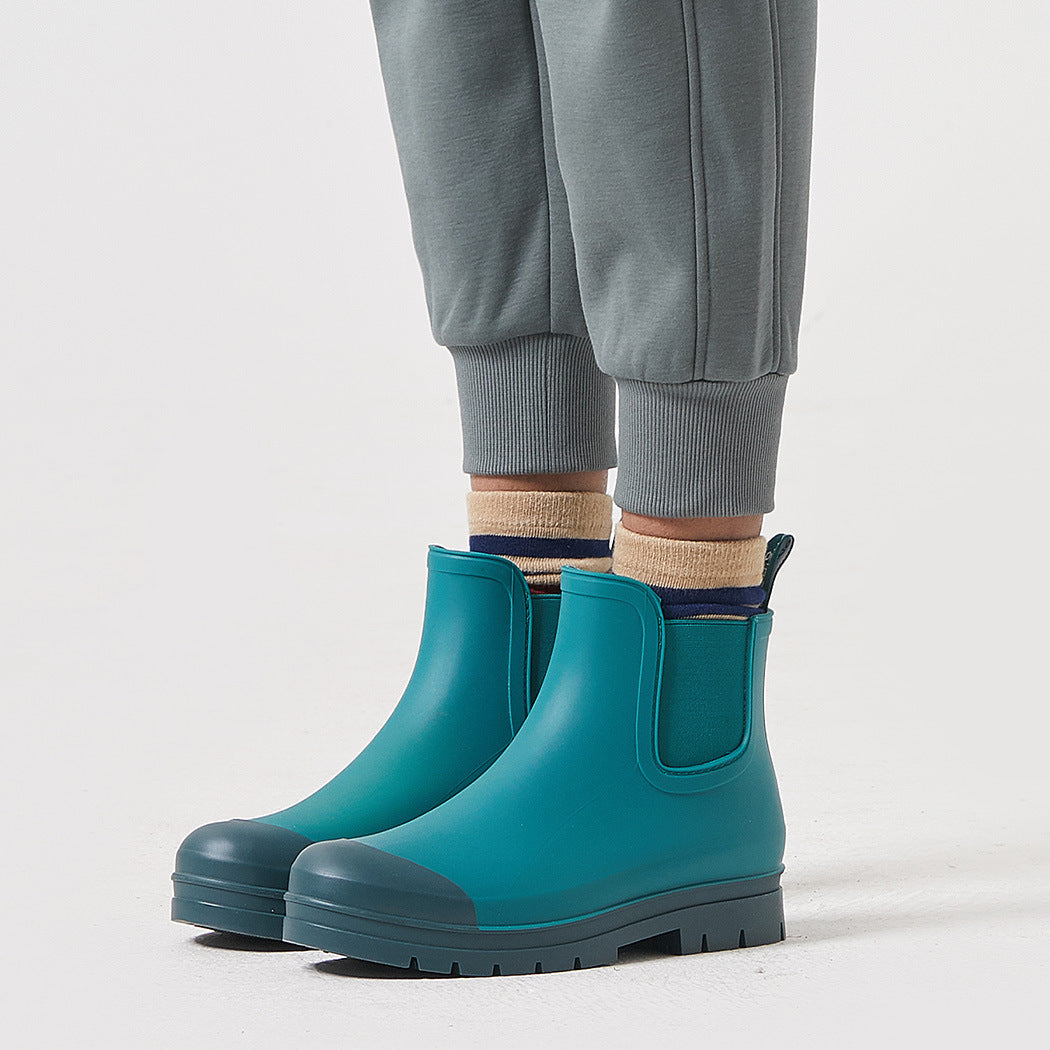 Teal short rain boots with pull-on side panels and non-slip tread sole