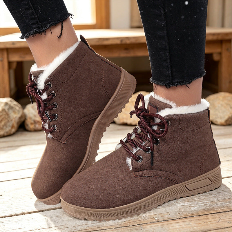Brown fleece-lined lace-up ankle boots with padded collars and textured soles, worn as a pair.