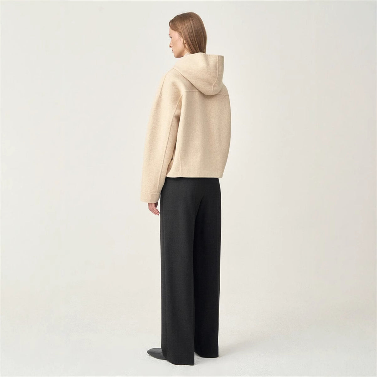 Oat short hooded wool coat, side view with draped hood and button closure