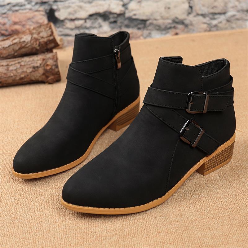 Black suede Chelsea ankle boots with side zipper, buckle strap, and block heel.