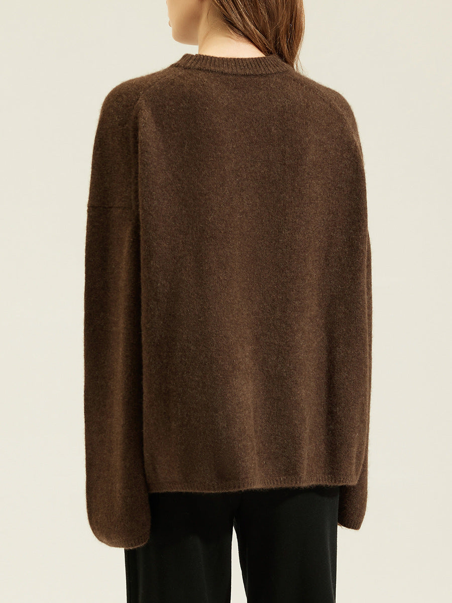 Back view of brown women's loose knit crewneck sweater with long sleeves