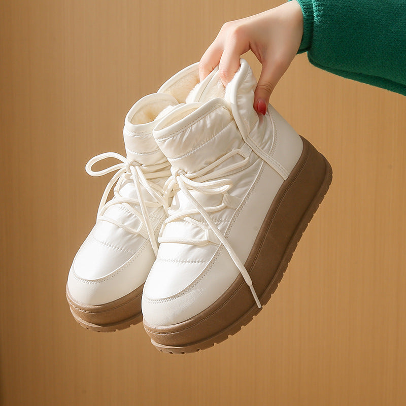 Cream high-top lace-up boots with fleece lining, brown sole, and lace-up front