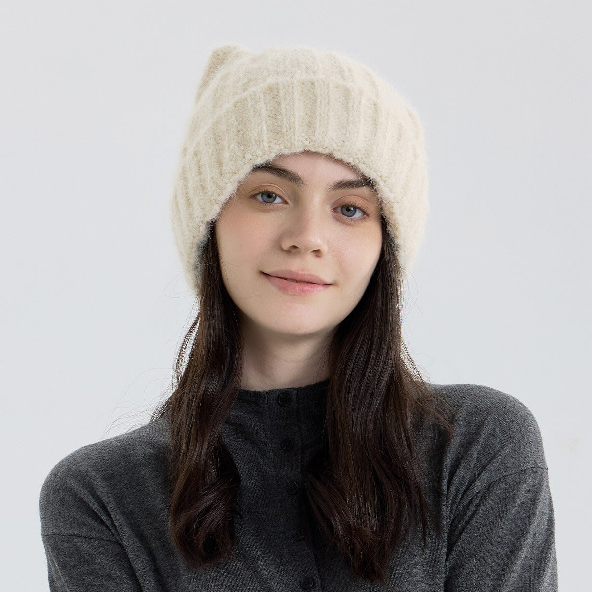 Beige cat-ear knit beanie with thick wool-like texture and ribbed knit band