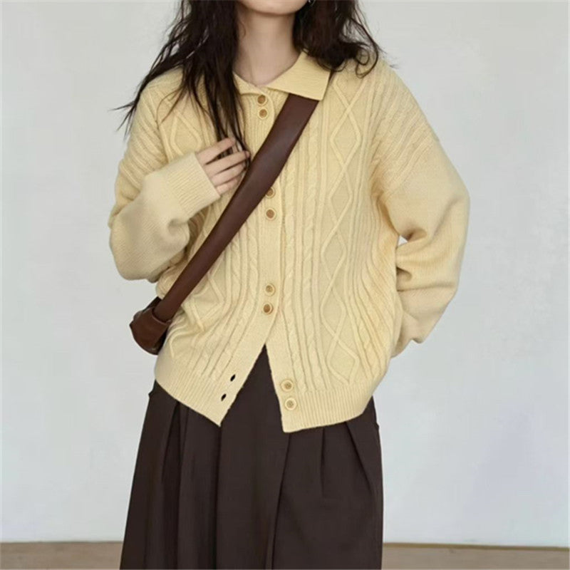 Pale yellow cable-knit button cardigan with pointed collar and roomy sleeves