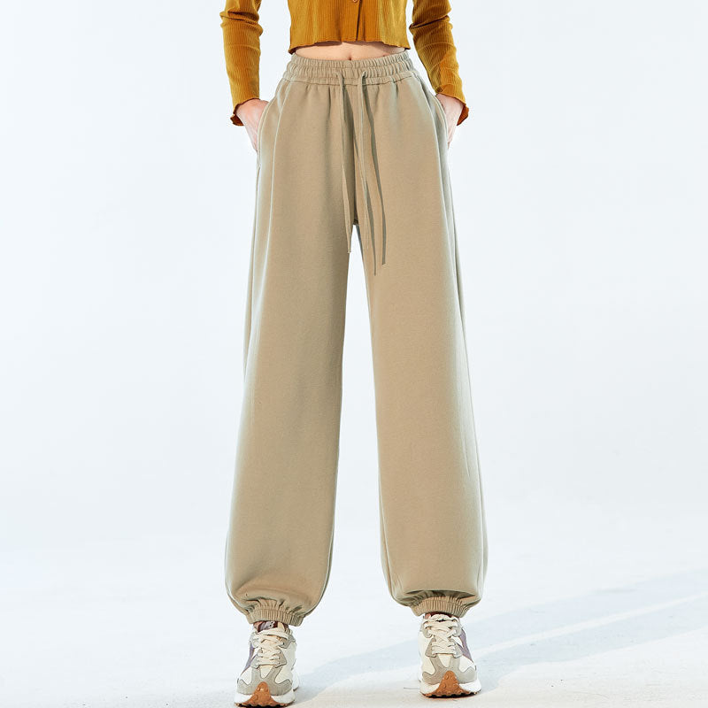 Beige high-waist relaxed sweatpants with drawstring and gathered hem cuffs.