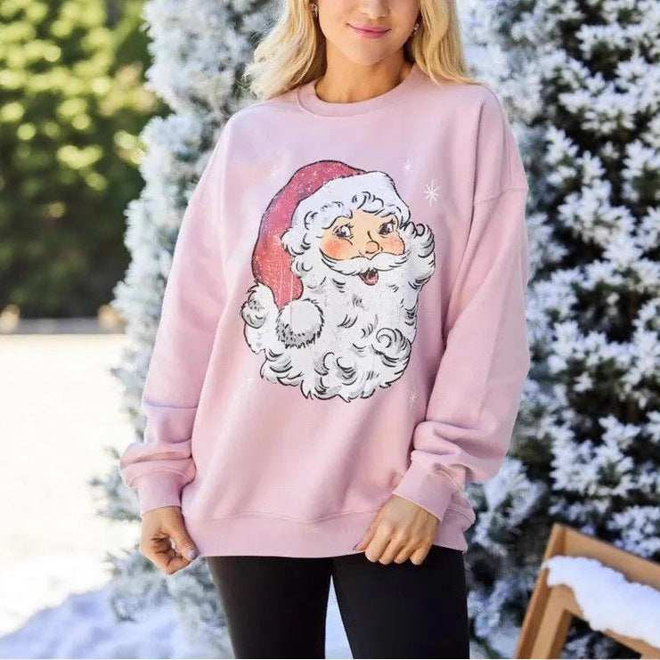 Women’s light pink sweatshirt with long sleeves and Santa face graphic, round crew neck
