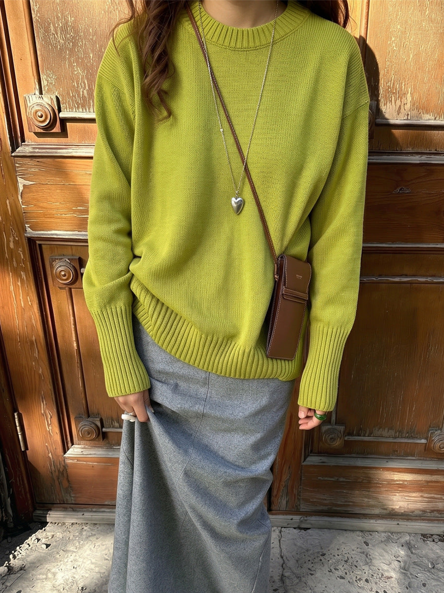 Women's green knit sweater with crew neck and long sleeves, ribbed hem and cuffs