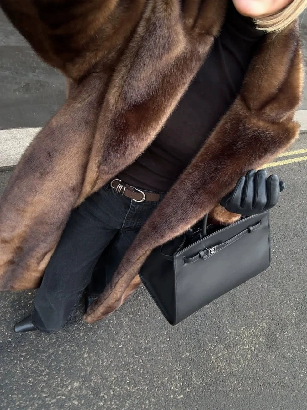 Brown faux fur coat close-up, long sleeves and soft plush pile