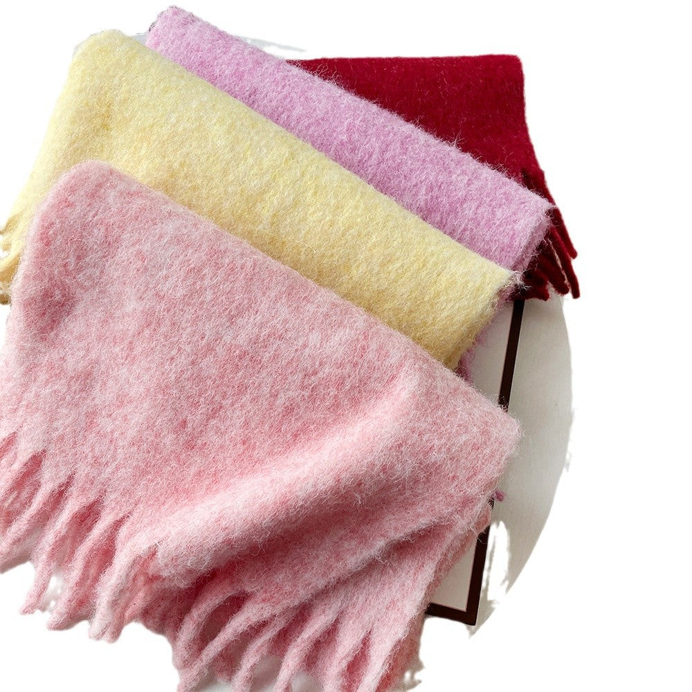 Women’s wool hair scarf, pink with fringe, shown alongside yellow and mauve tones