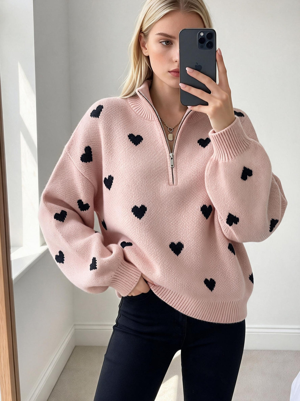 Pink heart-jacquard sweater with a quarter zip, ribbed collar and cuffs.