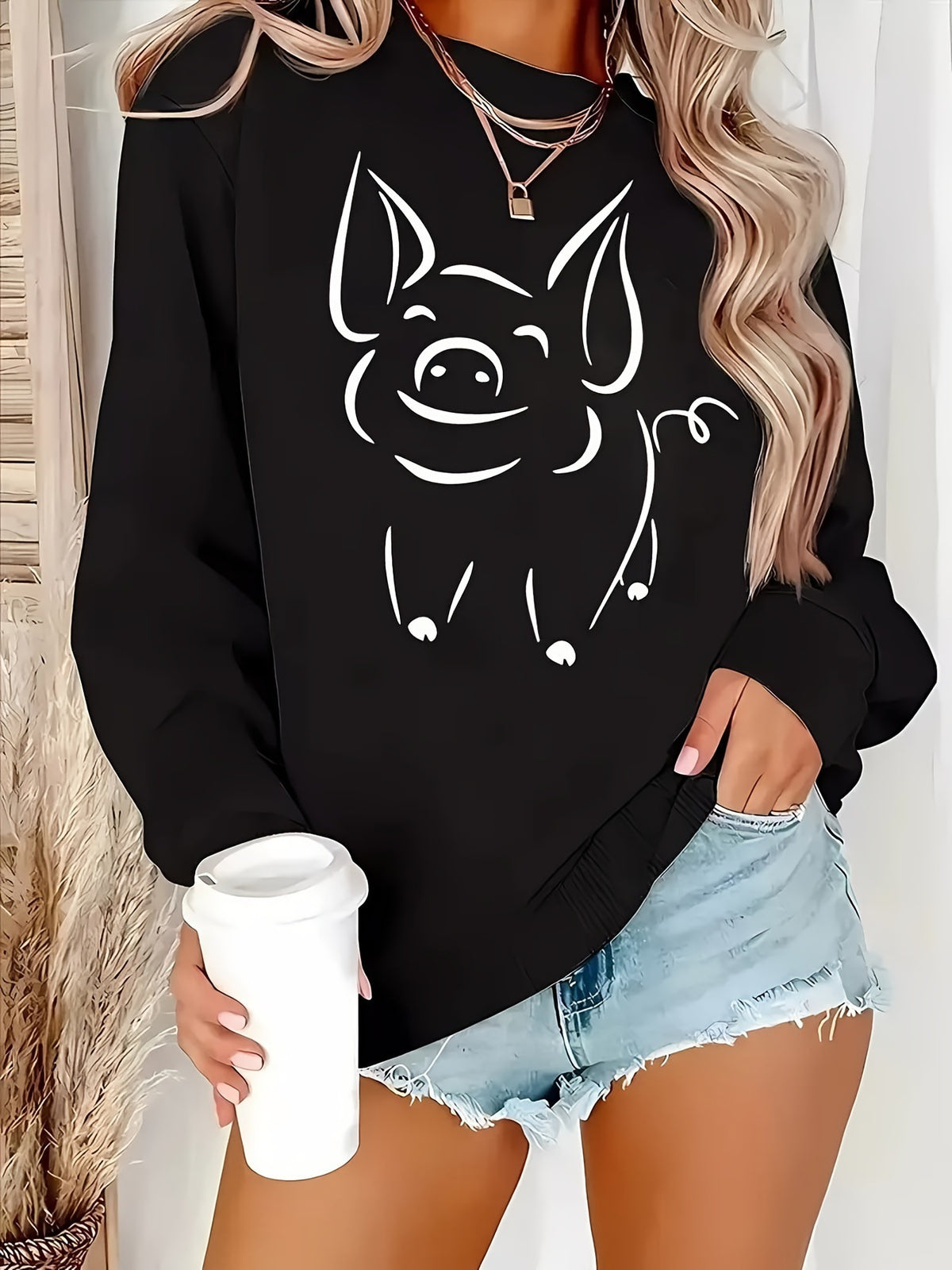Black women’s pullover hoodie with large smiling cat face graphic