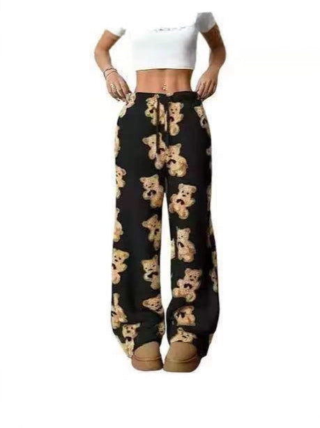 Loose fleece pants with black base and teddy bear print, drawstring waist