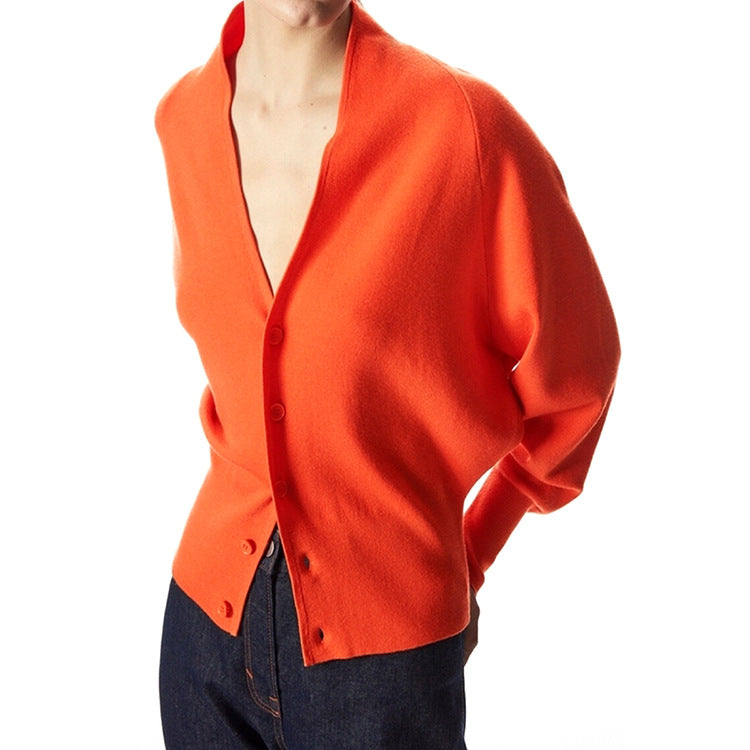 Orange v-neck cardigan sweater with front button placket and long sleeves