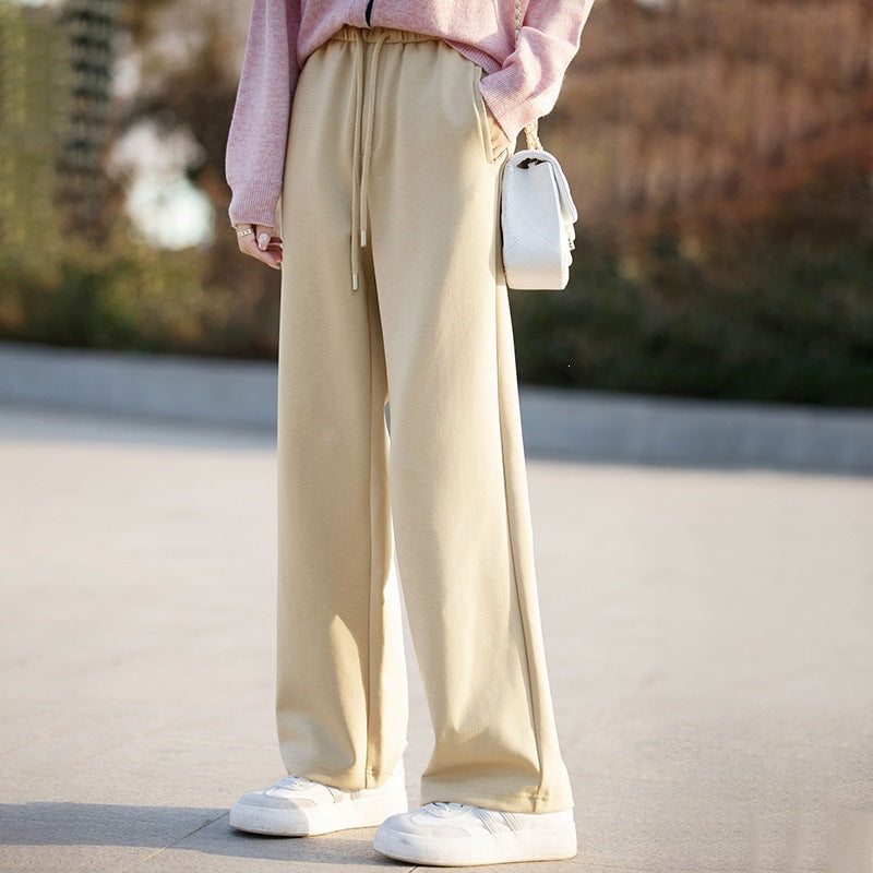 Women’s light khaki wide-leg pants with elastic waist drawstring and drapey straight-leg fit