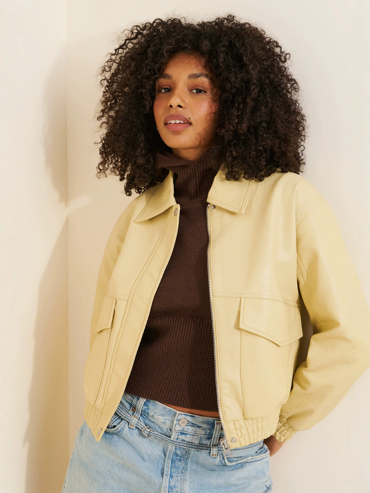 Light beige faux leather zip jacket with wide lapels and flap pockets