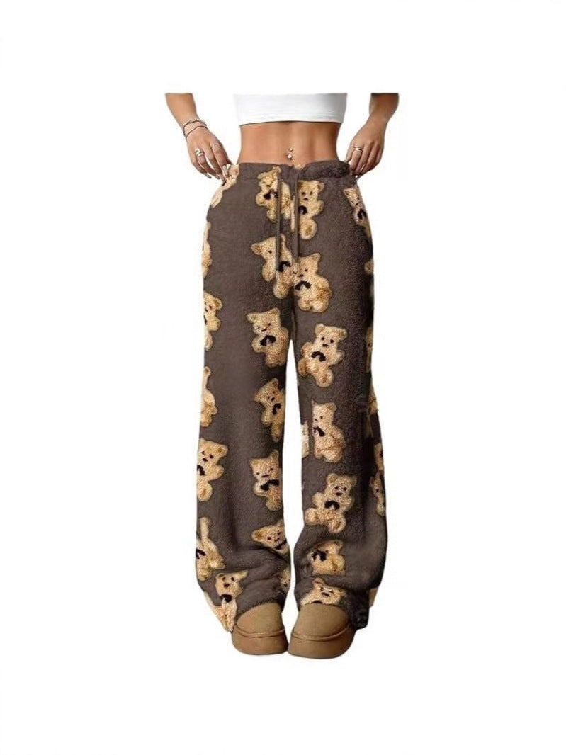 Loose fleece pants with dark base and teddy bear print, drawstring waist