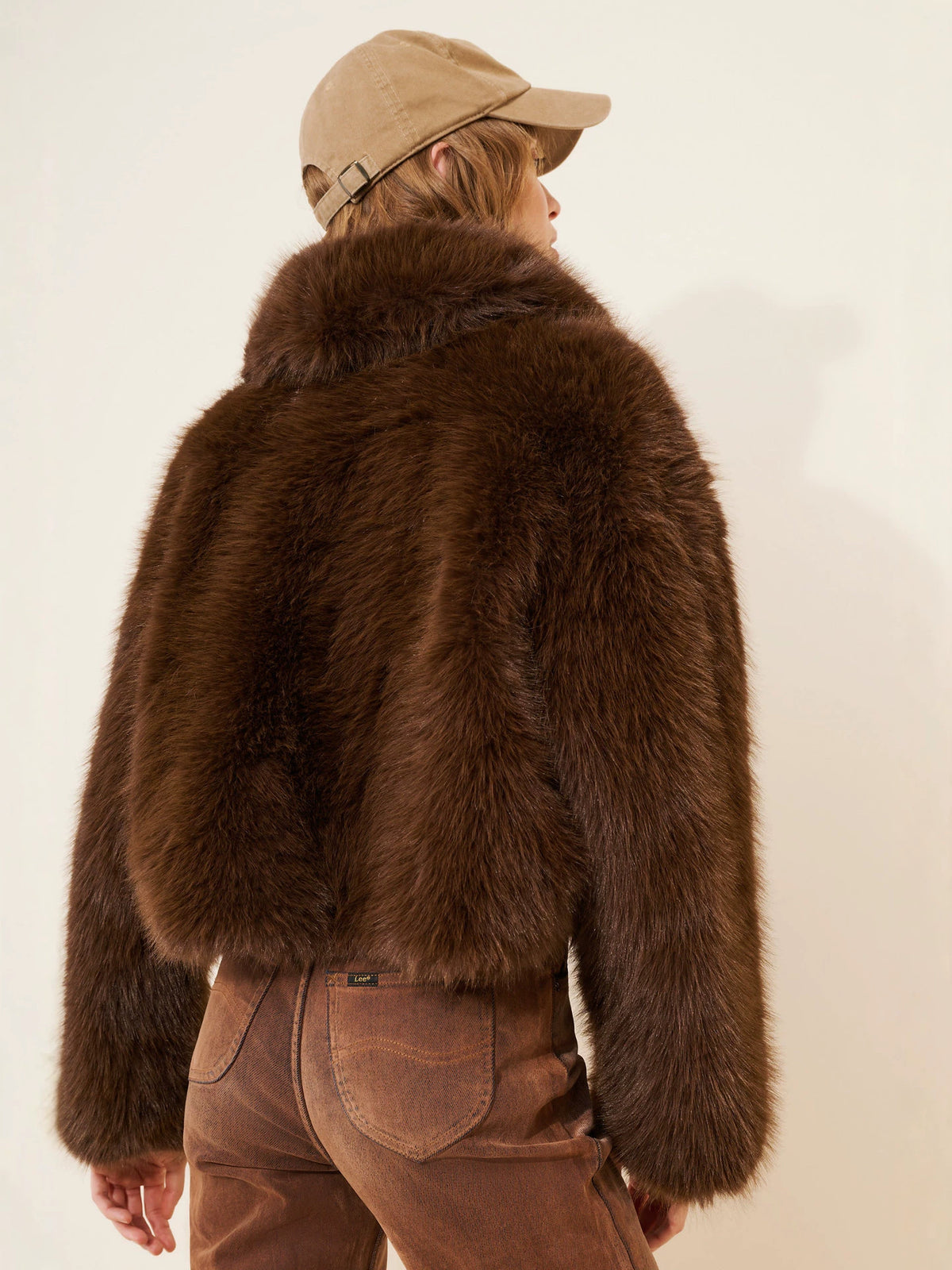 Women's brown faux fur short coat back view, plush texture and collar