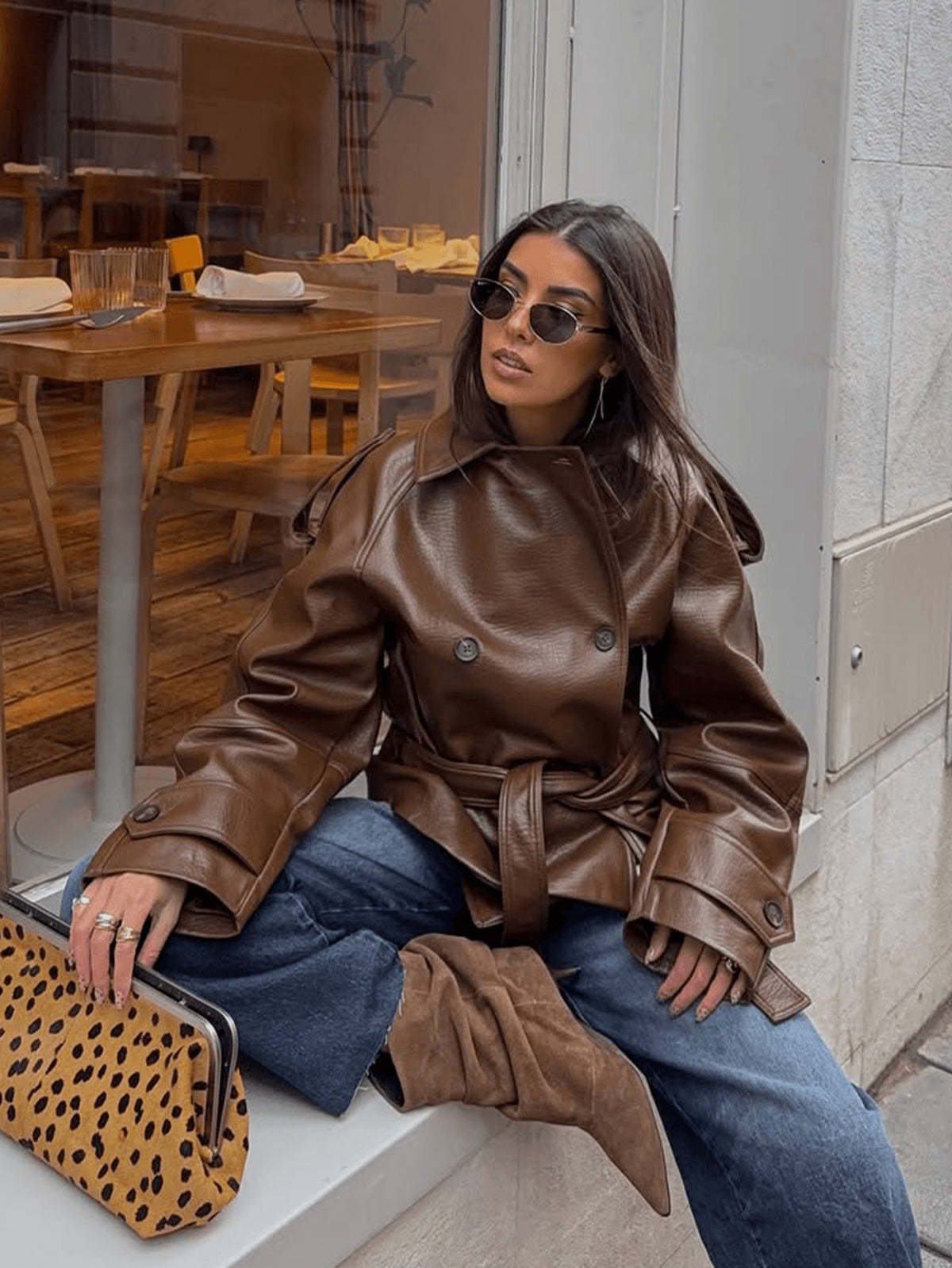 Brown pebbled leather short double-breasted belted motorcycle jacket, buttoned cuffs