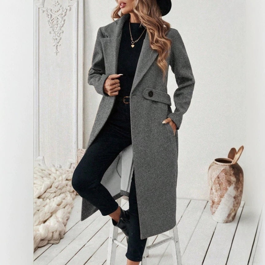 Gray wool long double-breasted coat with notched lapels, flap pockets, and button front.