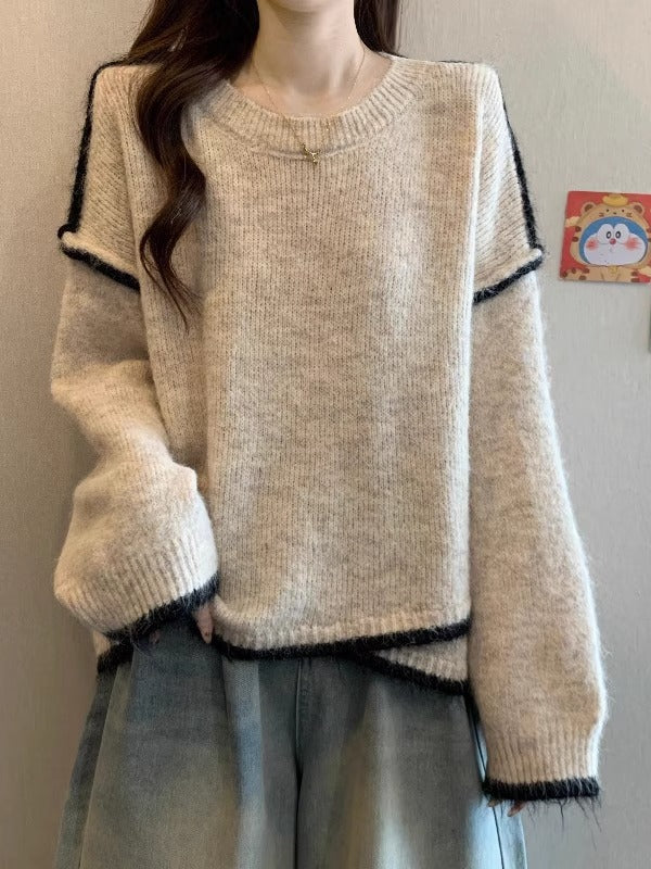 Light beige knit sweater with wide cuffs and black-and-white striped trim